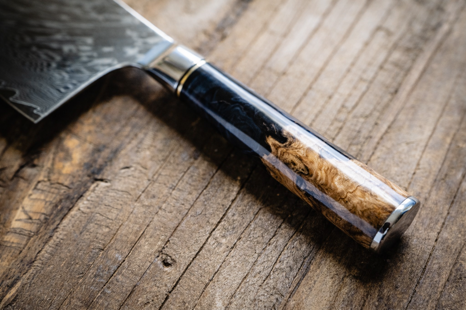 Black burl handle close-up on personalized engraved Damascus knife — Tidal Collection
